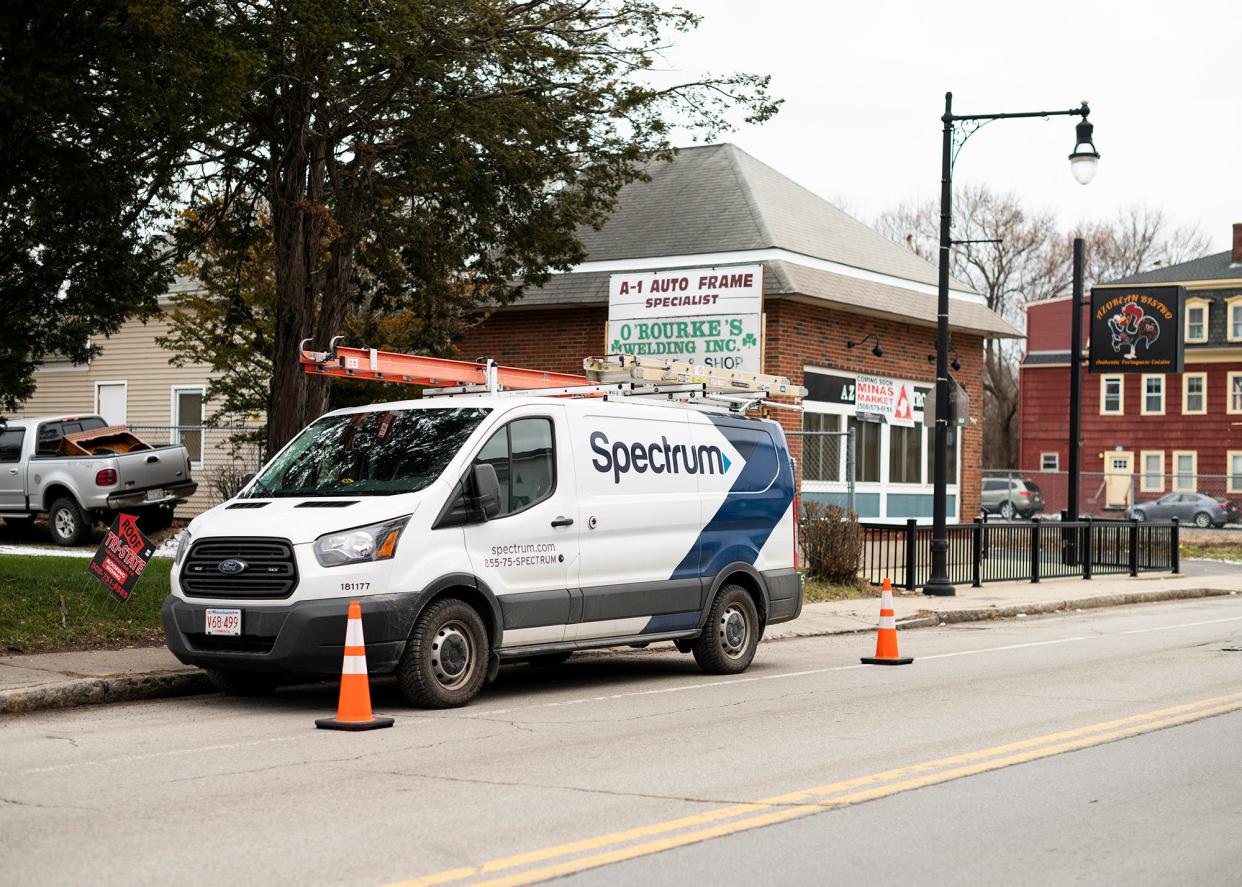 A Charter-Spectrum truck works on Greenwood Street.