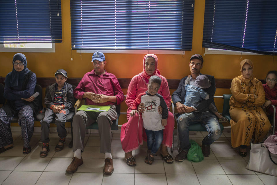 In this Wednesday, July 24, 2019 photo, families wait with their children affected by a rare disorder called xeroderma pigmentosum, or XP, inside a hospital in Casablanca, Morocco. The disorder affects about 1 in 10,000 people in North Africa _ more than 10 times the rate in Europe and about 100 times the rate in the United States, according to Dr. Kenneth Kraemer, who researches XP at the U.S. National Institutes of Health. (AP Photo/Mosa'ab Elshamy)