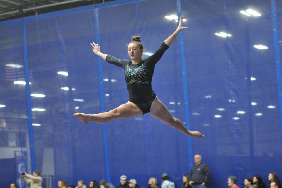 Hingham/Hull's Sienna Besser catches air during her balance beam routine at the Patriot League gymnastics meet at Starland in Hanover, Friday, Feb. 9, 2024.