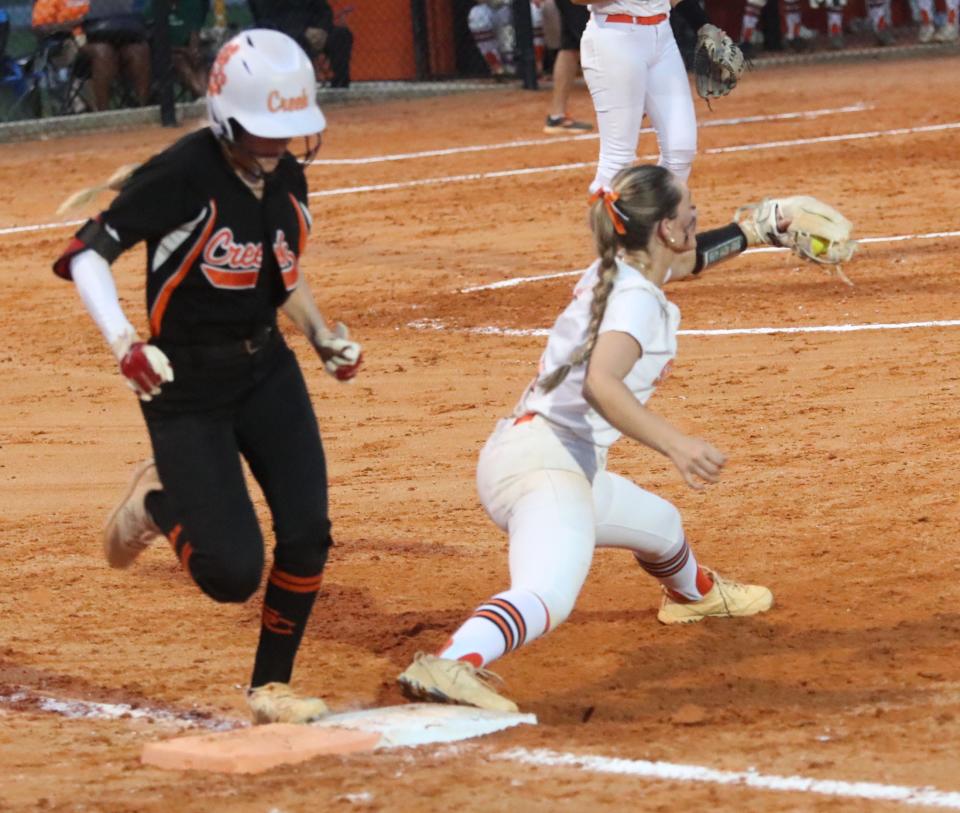 Spruce Creek High's Neena Hernandez #1 hustles to first to beat the throw to Seminole High's Ava Matthews #1, Tuesday May 14, 2024 during regional semifinal action in Port Orange.