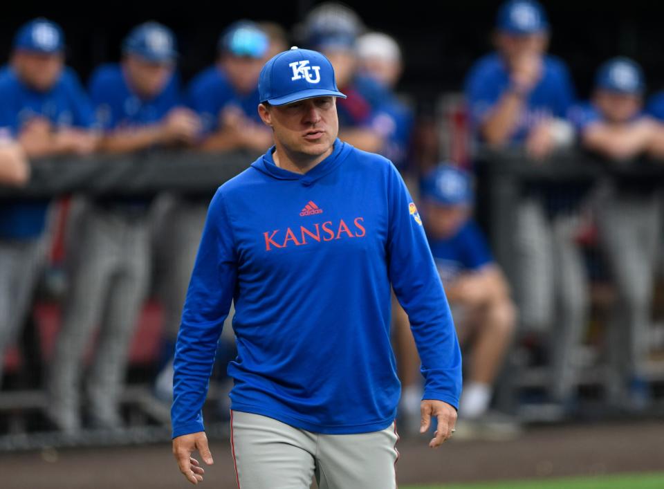 Kansas baseball coach Dan Fitzgerald walks to home plate during a game against Texas Tech on May 19, 2023, at Dan Law Field at Rip Griffin Park.