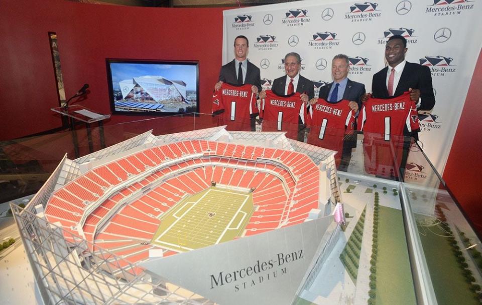 Matt Ryan (from left), Arthur Blank, Stephen Cannon and Julio Jones pose with a model of the new Falcons stadium, following announcement of deal Mercedes-Benz would pay for naming rights for new facility under construction in downtown Atlanta.