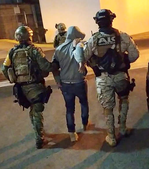 Members of the federal forces escort Jose Antonio Yepez in Guanajuato