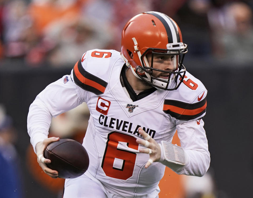 In this Dec. 29, 2019, photo, Cleveland Browns quarterback Baker Mayfield scrambles during the first half of an NFL football game against the Cincinnati Bengals in Cincinnati. The most compelling dramas in the NFL this season unfolded on the field, not off of it. And any thought that the league was in jeopardy of losing its spot as America's favorite sport has been set on the back burner. (AP Photo/Bryan Woolston)