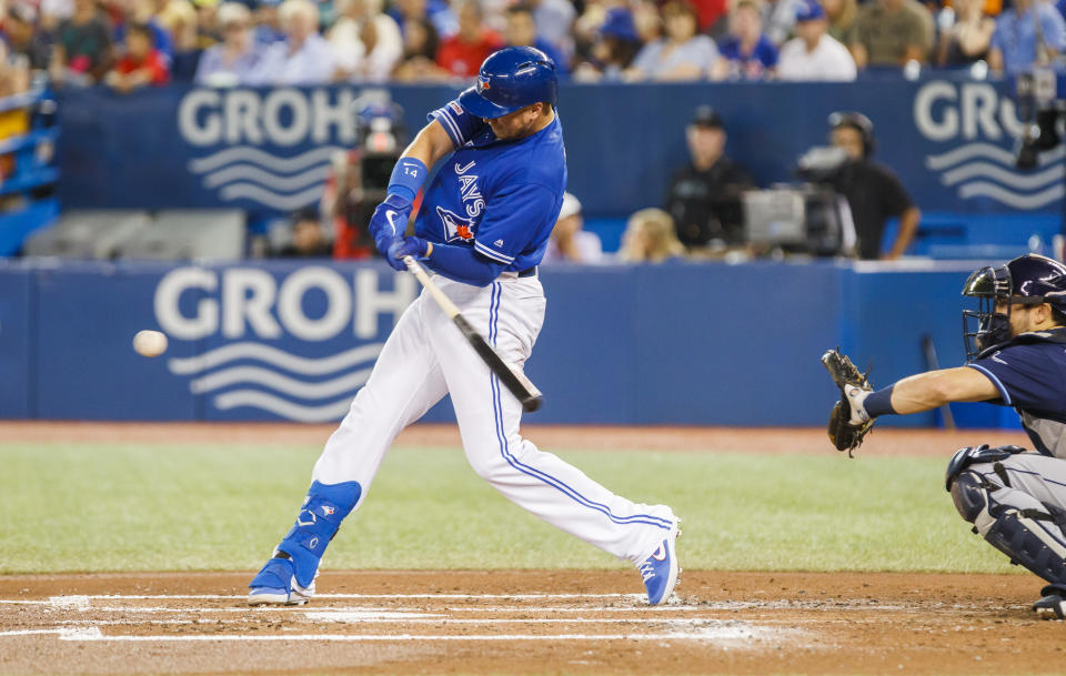 TORONTO, ONTARIO - JULY 28: Justin Smoak #14 of the Toronto Blue Jays hits a home run against the Tampa Bay Rays in the second inning during their MLB game at the Rogers Centre on July 28, 2019 in Toronto, Canada. (Photo by Mark Blinch/Getty Images)