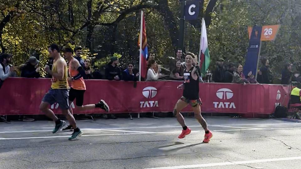 Calamia at Mile 26 of the New York City Marathon as he realizes he's in first place of the non-binary division.