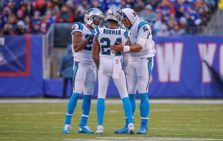 Dec 20, 2015; East Rutherford, NJ, USA; Carolina Panthers quarterback Cam Newton (right) and free safety Kurt Coleman (left) try to calm down cornerback Josh Norman (24) after unsportsmanlike penalty during the third quarter against New York Giants wide receiver Odell Beckham (not pictured) at MetLife Stadium. Mandatory Credit: Jim O'Connor-USA TODAY Sports