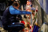 People gather to mourn the death of Argentine soccer legend Diego Maradona outside San Paolo stadium in Naples