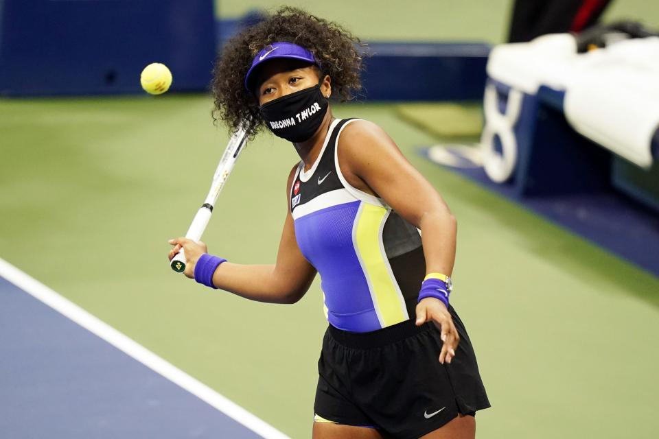 <p>Naomi Osaka wears a face mask honoring Breonna Taylor after winning the first round of the US Open against Misaki Doi on Monday in New York City. </p>