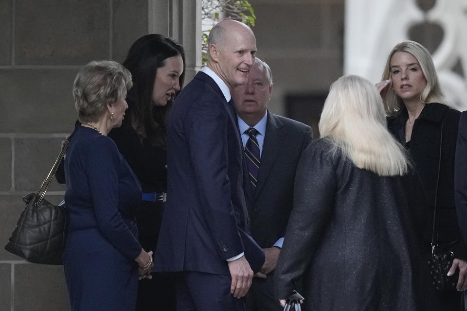 U.S. Sens. Rick Scott, R-Fla., center left, and Lindsey Graham, R-S.C., center right, greet other guests as they arrive for the funeral of former first lady Melania Trump's mother, Amalija Knavs, Thursday, Jan. 18, 2024, at the Church of Bethesda-by-the-Sea in Palm Beach, Fla. (AP Photo/Rebecca Blackwell)