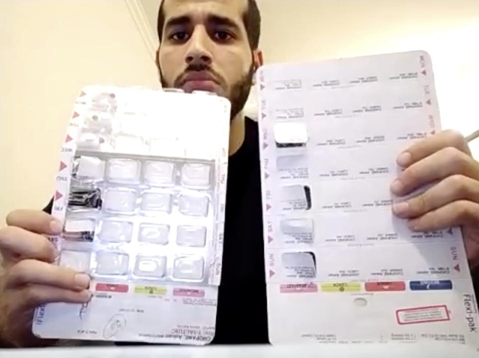 Adnan Choopani holds up medication packs that he said contained antidepressants and sleeping tablets. (Bianca Britton / NBC News)