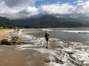 <p>People walk along a calm Hanalei Beach as Hurricane Lane approaches Kauai, Hawaii, Aug. 22, 2018. (Photo: Sue Horton/Reuters) </p>