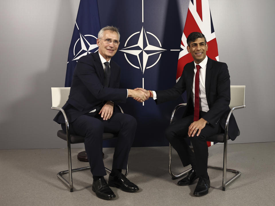 NATO Secretary General Jens Stoltenberg, left, and Britain's Prime Minister Rishi Sunak shake hands prior to talks at the Warsaw Armoured Brigade in Warsaw, Poland, Tuesday April 23, 2024. (Henry Nicholls/Pool via AP)