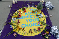 A sign that reads "My Faith Respects Your Choice" is visible on the ground as abortion rights advocates demonstrate in front of the U.S. Supreme Court, Wednesday, Dec. 1, 2021, in Washington, as the court hears arguments in a case from Mississippi, where a 2018 law would ban abortions after 15 weeks of pregnancy, well before viability. (AP Photo/Andrew Harnik)