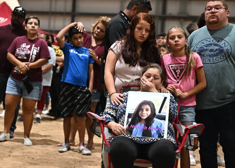 Uvalde, Texas May 25, 2022- Esmerralda Bravo holds a picture of her grandaughter Naveah, a shooting victim, Wednesday at the Uvalde County Fairplex to honor the fallen victims of a mass shooting during a vigil in Texas. Nineteen students and two teachers died when a gunman opened fire in a classroom yesterday. (Wally Skalij/Los Angeles Times)