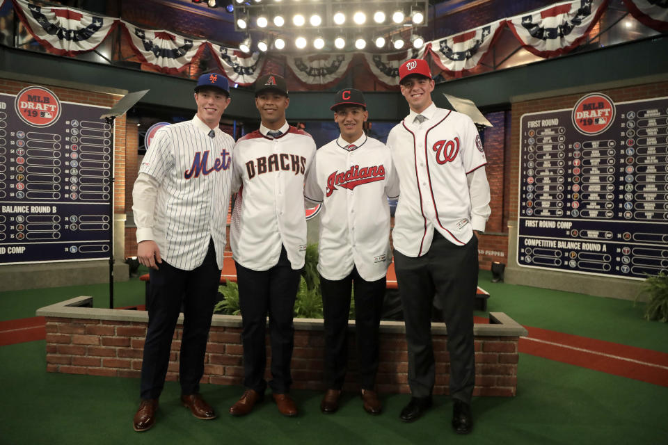 From left to right, prospects Brett Baty, Brennan Malone, Daniel Espino and Jackson Rutledge pose for photos after the first round of the Major League Baseball draft, Monday, June 3, 2019, in Secaucus, N.J. (AP Photo/Julio Cortez)