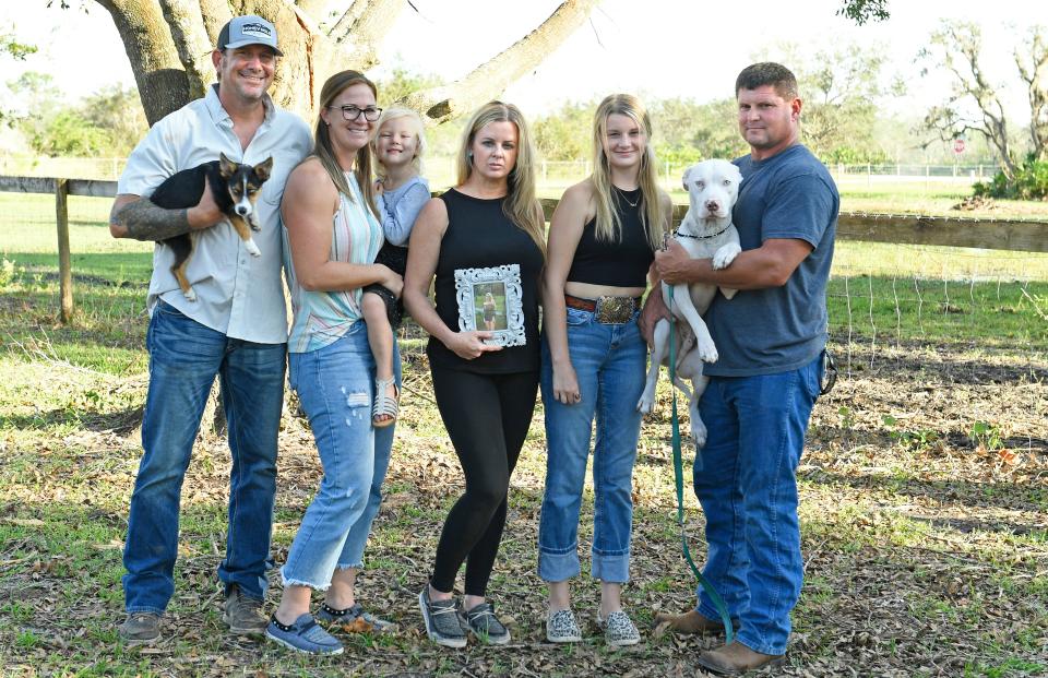 Ashley Jade Zadai's family gathers for a family portrait in her memory for the Herald-Tribune. Members are dad, Pat Zadai holding Aussi, stepmom, Sabrina Zadai holding little sister Bristol Zadai, 3, mom Beth Doerner, sister Skylar Zadai, 15, stepdad Dan Armstrong holding Kilo.