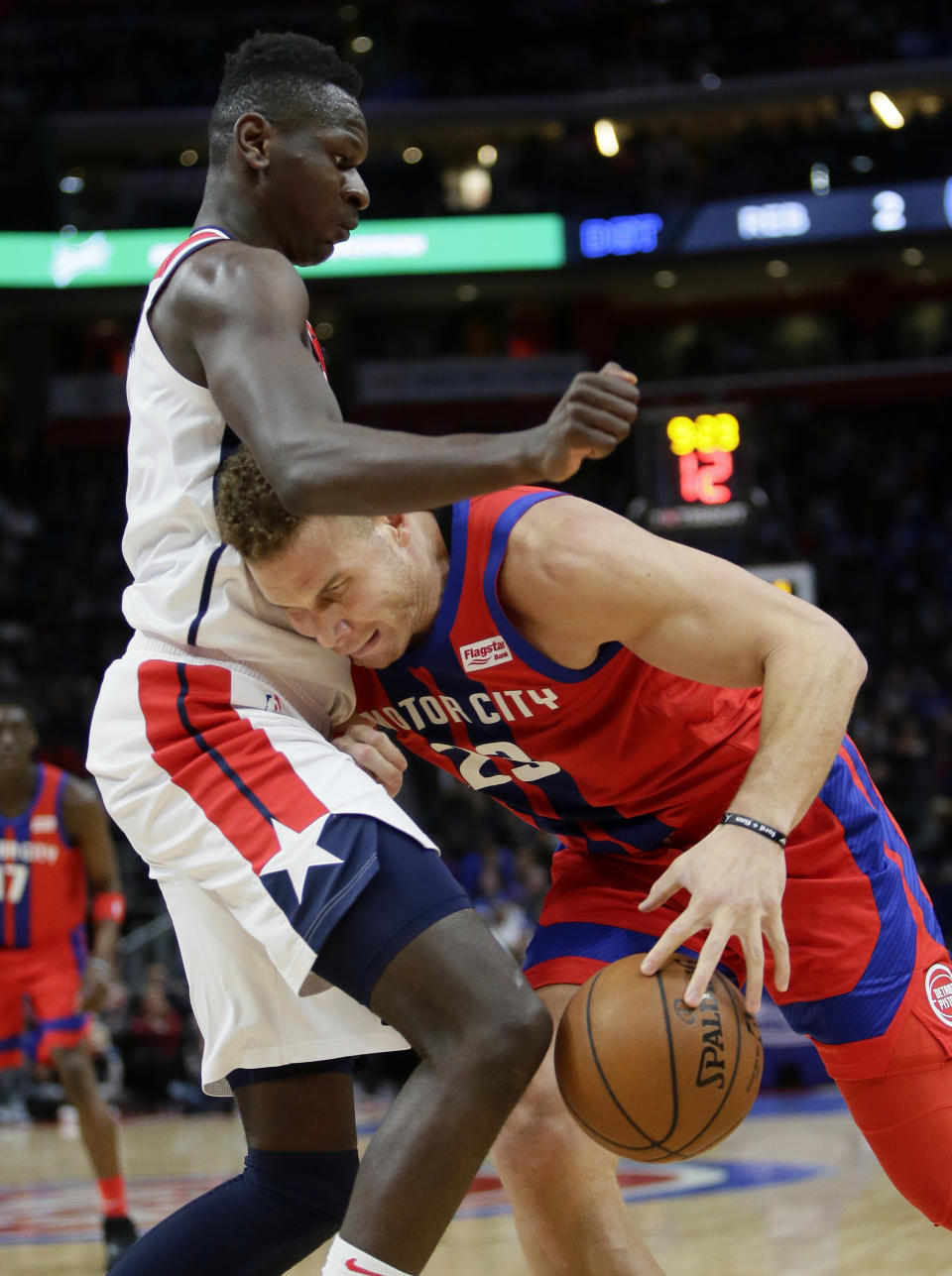 Detroit Pistons forward Blake Griffin (23) collides with Washington Wizards guard Isaac Bonga, top, while trying to go to the basket during the first half of an NBA basketball game Thursday, Dec. 26, 2019, in Detroit. (AP Photo/Duane Burleson)