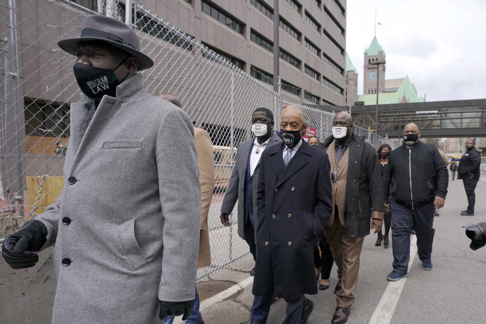 In this Monday, April 19, 2021 file photo, Ben Crump, left, attorney representing George Floyd’s family, walks with the Rev. Al Sharpton, center, and Floyd’s brothers Terrence Floyd, center left, and Rodney Floyd, center right, outside of the Hennepin County Government Center in Minneapolis, before the murder trial against former Minneapolis police officer Derek Chauvin advances to jury deliberations. (AP Photo/Julio Cortez)