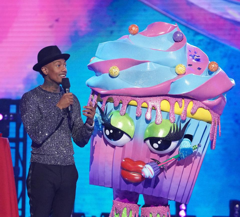 "Masked Singer" host Nick Cannon with contestant Cupcake.