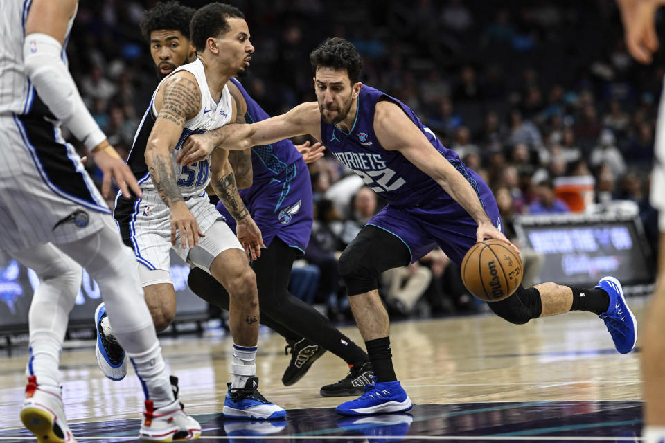 Charlotte Hornets guard Vasa Micic (22) attempts to drive past Orlando Magic guard Cole Anthony (50) during the first half of an NBA basketball game, Tuesday, March 5, 2024, in Charlotte, N.C. (AP Photo/Matt Kelley)