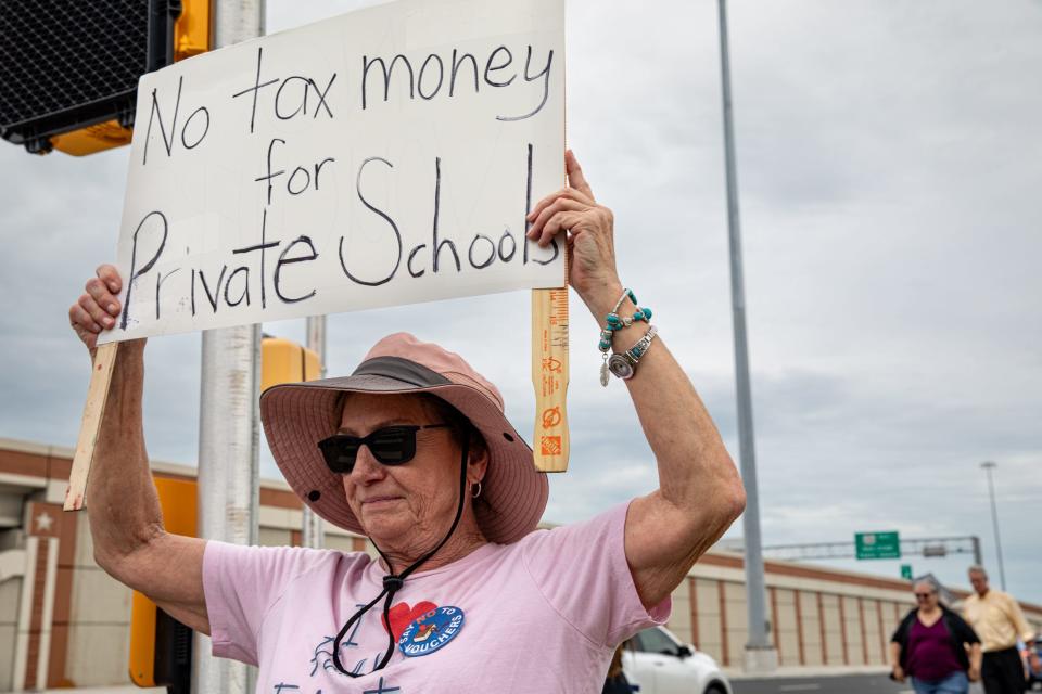 Frances Carney, a retired language pathologist with Rockport-Fulton and Ingleside, protests with the Corpus Christi American Federation of Teachers against school vouchers and for Proposition 9 on Monday, Oct. 9, 2023, in Corpus Christi, Texas.