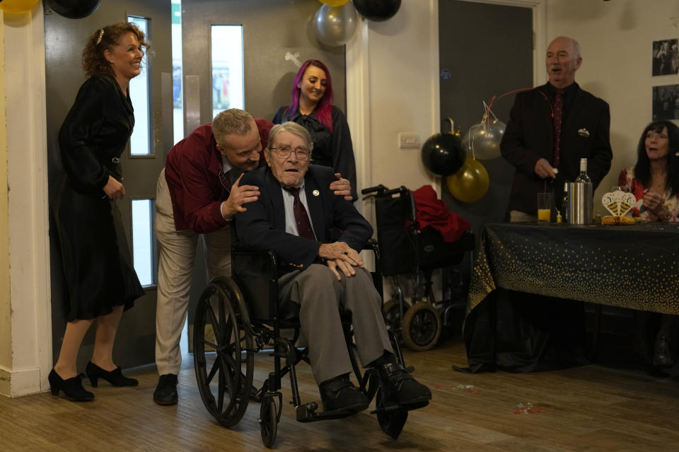 D-Day veteran Bill Gladden reacts as he arrives at a surprise 100th birthday party Haverhill, England, Friday, Jan. 12, 2024. Gladden spoke to the AP on the eve of his 100th birthday, and is a veteran of the 6th Airborne Armoured Reconnaissance Regiment, part of the British 6th Airborne Division, he landed by glider on the afternoon of D-day, 6th June 1944 in Normandy. Gladden was born January. 13, 1924. (AP Photo/Alastair Grant)