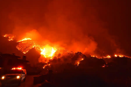 Thomas wildfire burns above Bella Vista Drive near Romero Canyon in this social media photo by Santa Barbara County Fire Department in Montecito, California, U.S. December 12, 2017. Courtesy Mike Eliason/Santa Barbara County Fire Department/Handout via REUTERS