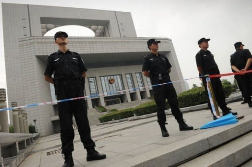 Policemen stand guard outside the Intermediate People's Court in Hefei, Anhui province where four Chinese police officers are on trial in the Gu Kailai case. The wife of a former Chinese top politician at the heart of a scandal that has rocked the ruling Communist Party, has admitted murdering a British businessman and blamed her actions on a "mental breakdown," according to state media