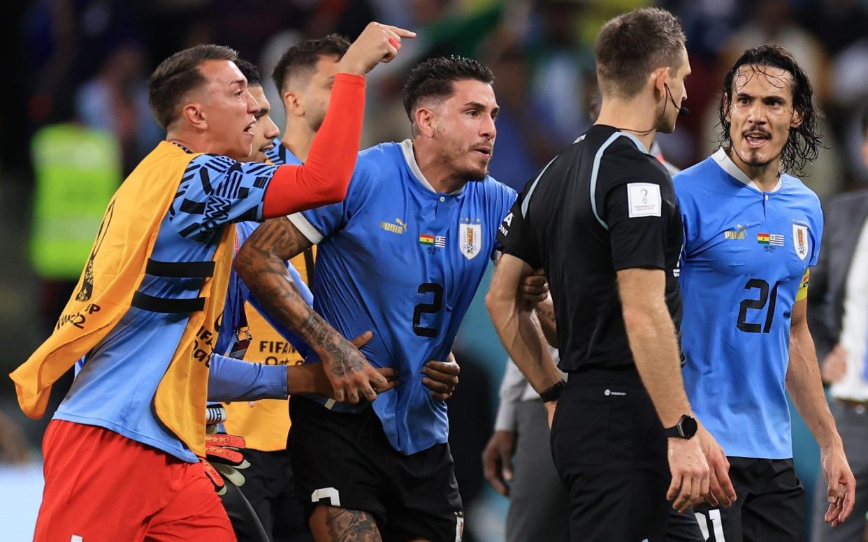 Uruguay players argue with referee Daniel Siebert after the FIFA World Cup Qatar 2022 Group H match between Ghana and Uruguay at Al Janoub Stadium - Getty Images