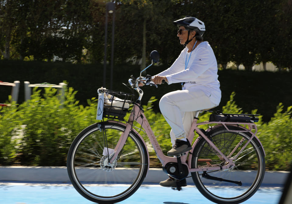 Dorothee Hildebrandt, 72, rides her bike to the U.N. climate summit COP27 in Sharm el-Sheikh, Egypt, Saturday, Nov. 12, 2022. Hildebrandt biked from Sweden to Sharm el-Sheikh, Egypt, for COP27 to raise awareness and urge world leaders gathered at the conference to take concrete steps to stop climate change. (AP Photo/Thomas Hartwell)