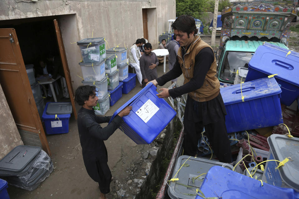 Afghan workers of the election commission office unload ballot boxes from a truck after votes in Jalalabad, east of Kabul, Afghanistan, Sunday, April 6, 2014. Across Afghanistan, voters turned out in droves Saturday to cast ballots in a crucial presidential election. The vote will decide who will replace President Hamid Karzai, who is barred constitutionally from seeking a third term. Partial results are expected as soon as Sunday. (AP photo/Rahmat Gul)