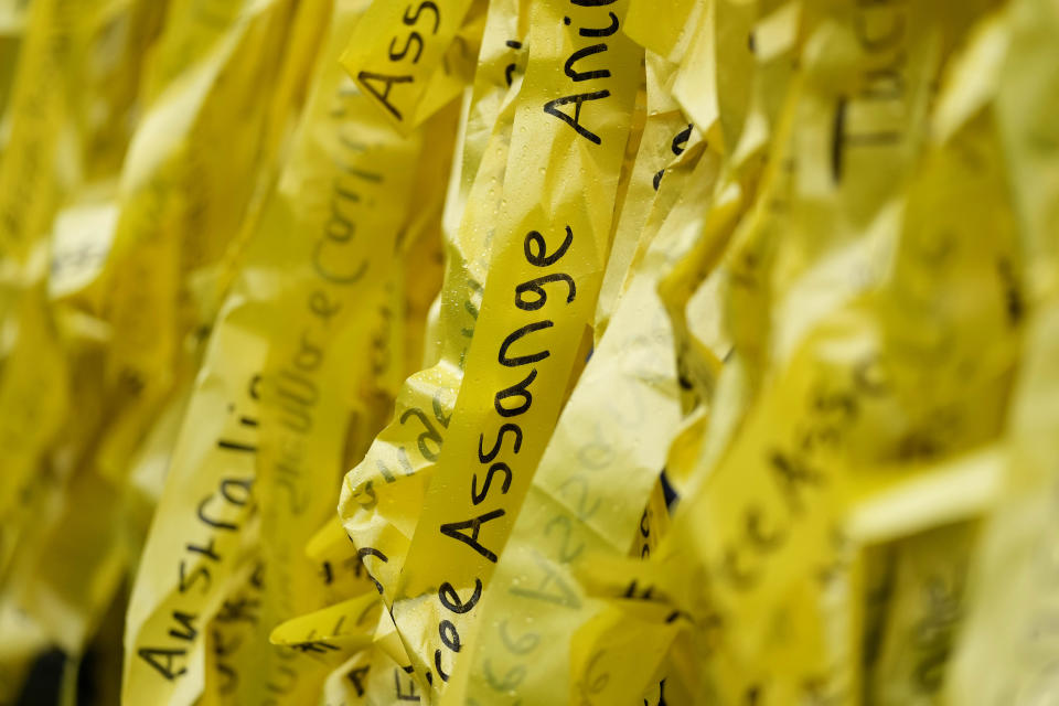 Yellow ribbons are fixed by protesters to the railings the Royal Courts of Justice entrance in London, Wednesday, Feb. 21, 2024. Julian Assange's lawyers are on their final U.K. legal challenge to stop the WikiLeaks founder from being sent to the United States to face spying charges. The 52-year-old has been fighting extradition for more than a decade, including seven years in self-exile in the Ecuadorian Embassy in London and the last five years in a high-security prison. (AP Photo/Kin Cheung)