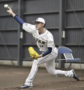 Japanese pitcher Roki Sasaki throws a ball during a team camp of the World Baseball Classic, in Miyazaki, southern Japan, on Feb. 19, 2023. All eyes will be on Japanese baseball pitcher Sasaki at the World Baseball Classic. He is regarded as the next big thing in baseball out of Japan. (Kyodo News via AP)
