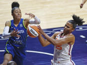 Connecticut Sun forward Alyssa Thomas (25) takes a rebound away from Minnesota Lynx forward Aerial Powers (3) during a WNBA basketball game, Sunday, Aug. 14, 2022, in Uncasville, Conn. (Sean D. Elliot/The Day via AP)