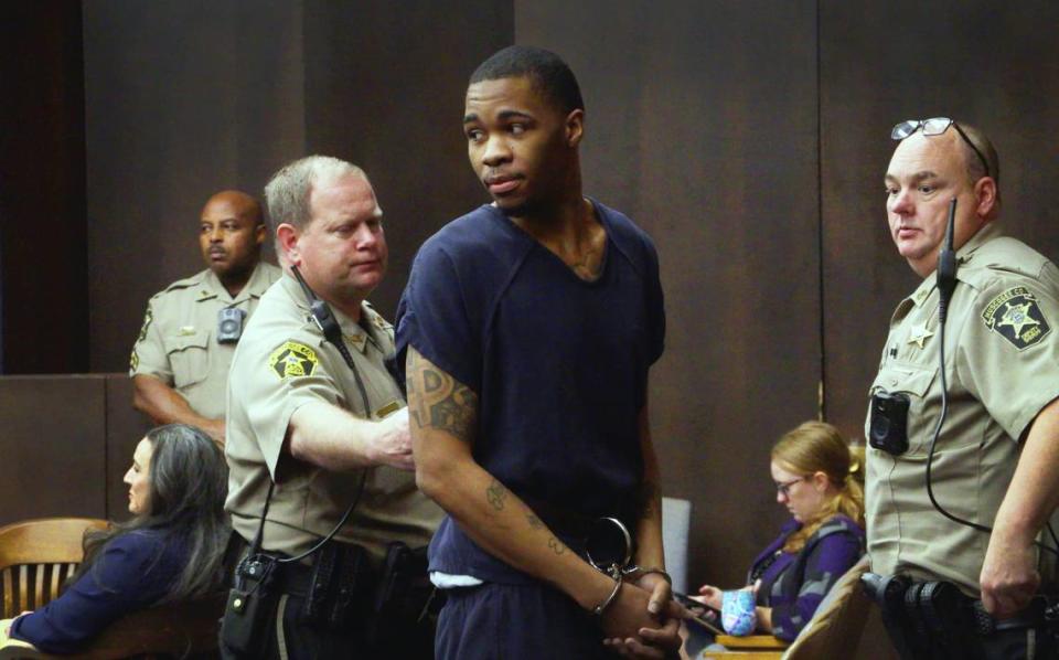 Anthony Nathan Foster, 26, center, is escorted from the courtroom Wednesday morning after receiving his sentence from Superior Court Judge John Martin. Foster pleaded guilty to home invasion, armed robbery, aggravated assault, false imprisonment and violating Georgia’s gang terrorism act. He was sentenced to 30 years in prison with 18 to serve and the rest on probation. 02/08/2023