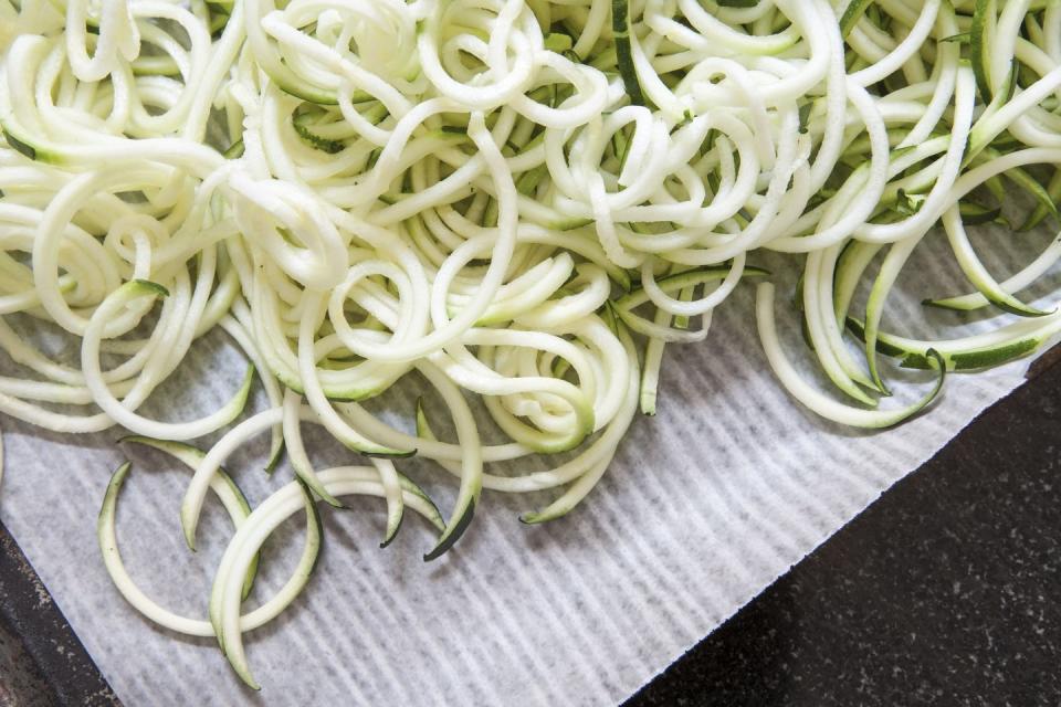 close up of fresh zucchini noodles in baking pan