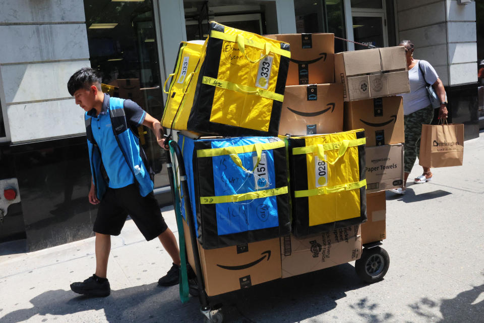 NEW YORK, NEW YORK - JULY 12: An Amazon workers pull a cart of packages for delivery on E 14th Street on July 12, 2022 in New York City. Amazon is holding Amazon Prime Day in more than 20 countries, offering exclusive discounts on thousands of products, from July 12-13. The two-day sale began on 2015 as a celebration of the retailer's 20th anniversary. (Photo by Michael M. Santiago/Getty Images)