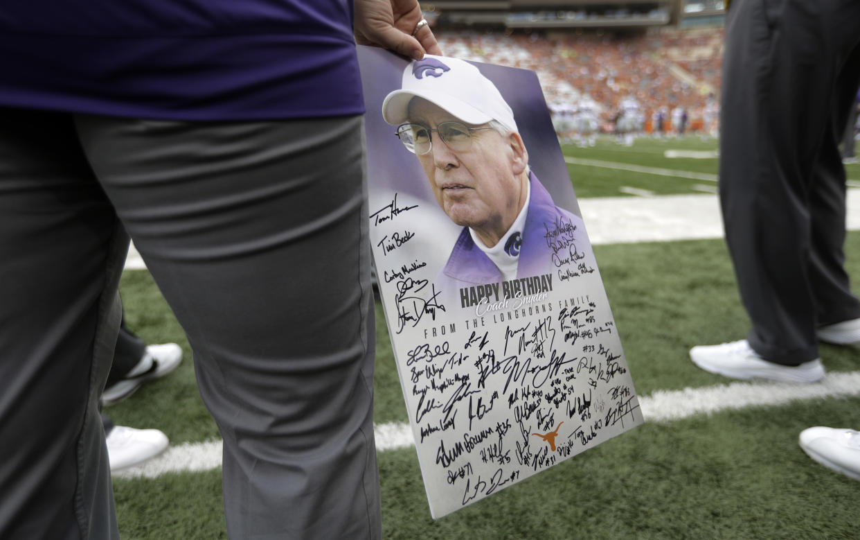 A Kansas State staff member holds a birthday card signed by Texas players and coaches that was presented to Kansas State head coach Bill Snyder, who is celebrating his birthday today, before their NCAA college football game, Saturday, Oct. 7, 2017, in Austin, Texas. Snyder is 78 today. (AP Photo/Eric Gay)