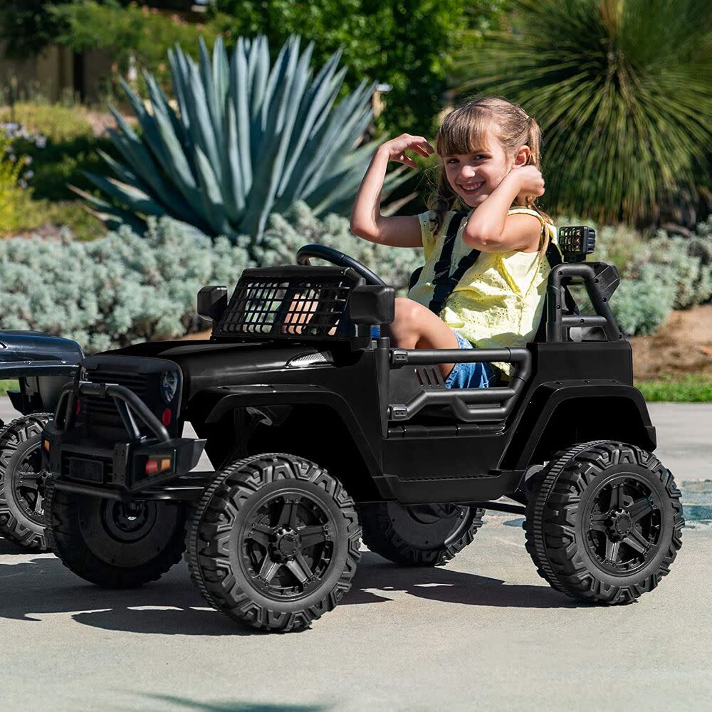 young girl driving power wheel.