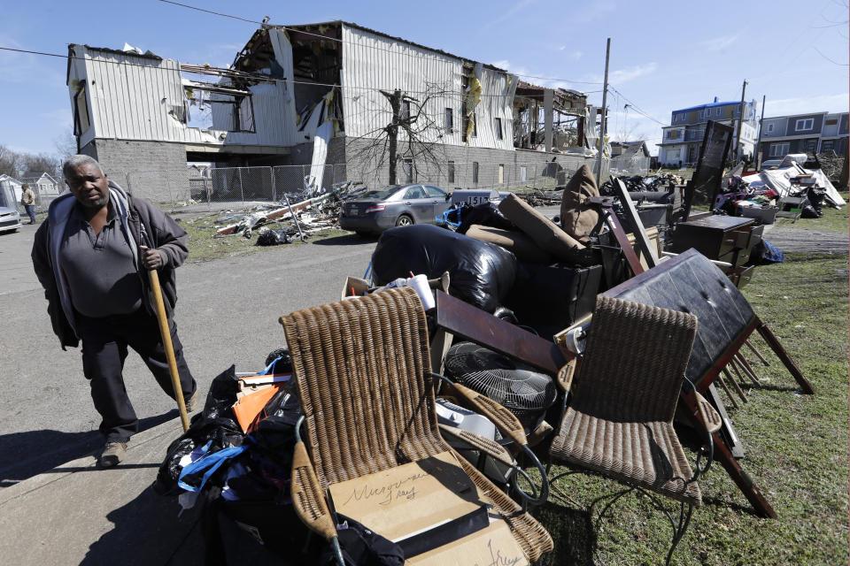 Gene Hancock views damaged goods piled near the street as he leaves a worship service at Mount Bethel Missionary Baptist Church, Sunday, March 8, 2020, in Nashville, Tenn. The congregation held their service in a tent in the parking lot near the church facilities, which were heavily damaged by a tornado March 3. (AP Photo/Mark Humphrey)