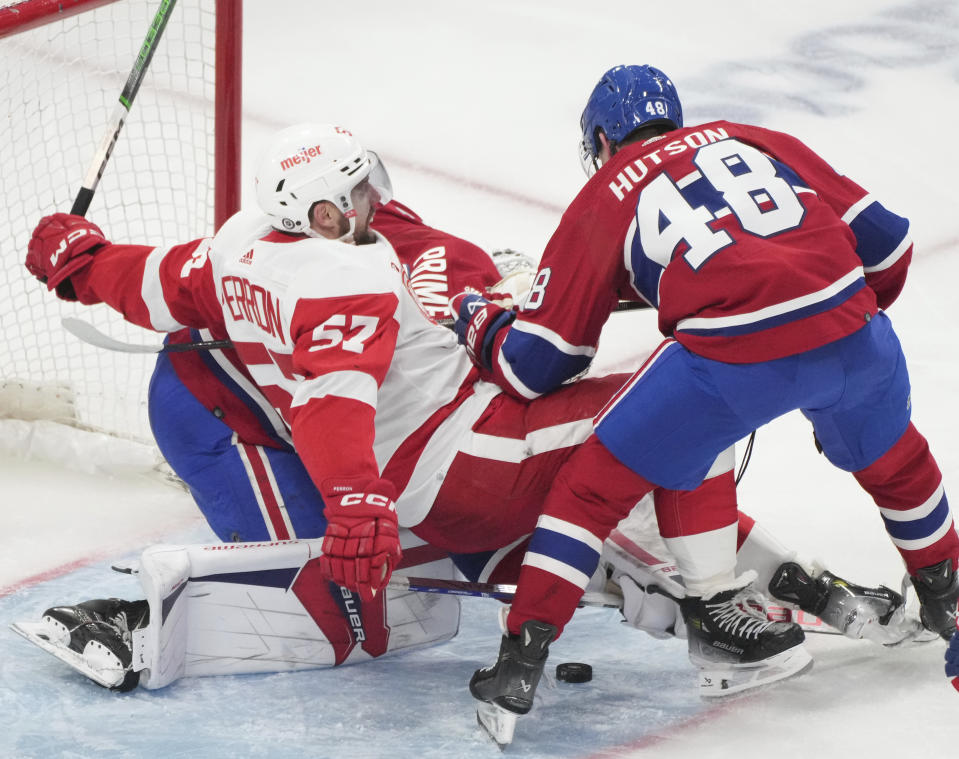 Montreal Canadiens' Lane Hutson (48) battles Detroit Red Wings' David Perron (57) in front of the net during the second period of an NHL hockey game Tuesday, April 16, 2024, in Montreal. (Christinne Muschi/The Canadian Press via AP)