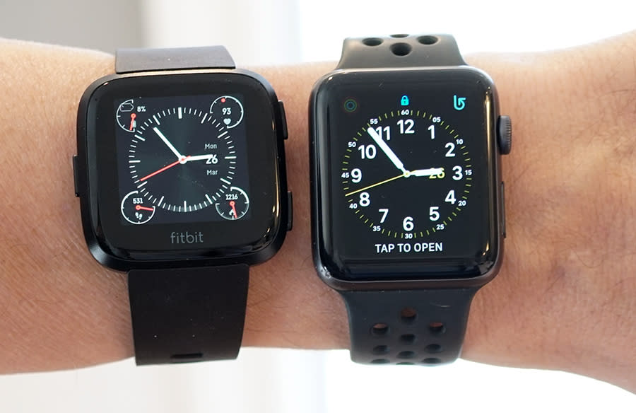 The Versa (left) is slightly wider, but shorter, than the 42mm Apple Watch.