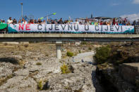 Environmental activists wave behind a banner reading "Do not put Cijevna in pipes" during a protest in Dinosa village, near Tuzi, Montenegro October 20, 2018. REUTERS/Stevo Vasiljevic