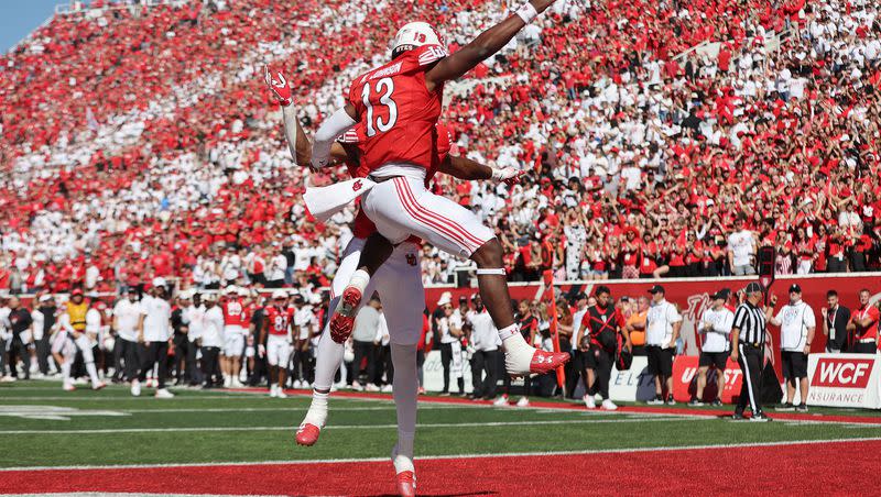 Utah Utes quarterback Nate Johnson (13) celebrates the touchdown with Utah Utes receiver Landen King(82) in Salt Lake City on Saturday, Sept. 23, 2023.