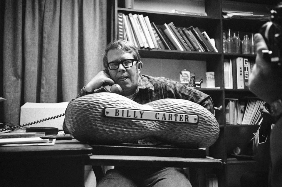 FILE - In this Jan. 18, 1977, file photo, Billy Carter, younger brother of President-elect Jimmy Carter, talks on the phone on Jan. 18, 1977, in Plains,. Ga. (AP Photo/File)