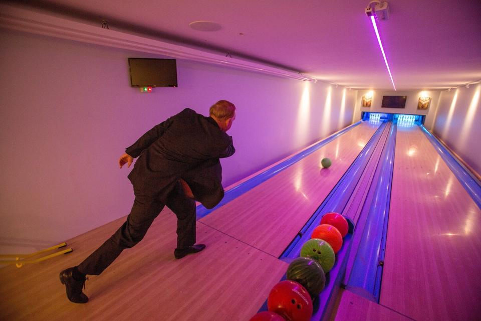 Graham Wildin inside the leisure centre he has built for himself and his family in his back garden (file pic) See SWNS story SWBRcave; A man ordered to knock down 'Britain's best man cave' which he built illegally in his back garden has been told to pay £30,000 to the council to cover its prosecution costs. Graham Wildin, 66, spent four years battling with authorities over the private leisure complex. It contains a bowling alley, cinema, casino and a gym - and pictures from Google Earth show it looking like a massive factory. But a High Court judge said the granddad-of-five must comply with the council and remove the centre.