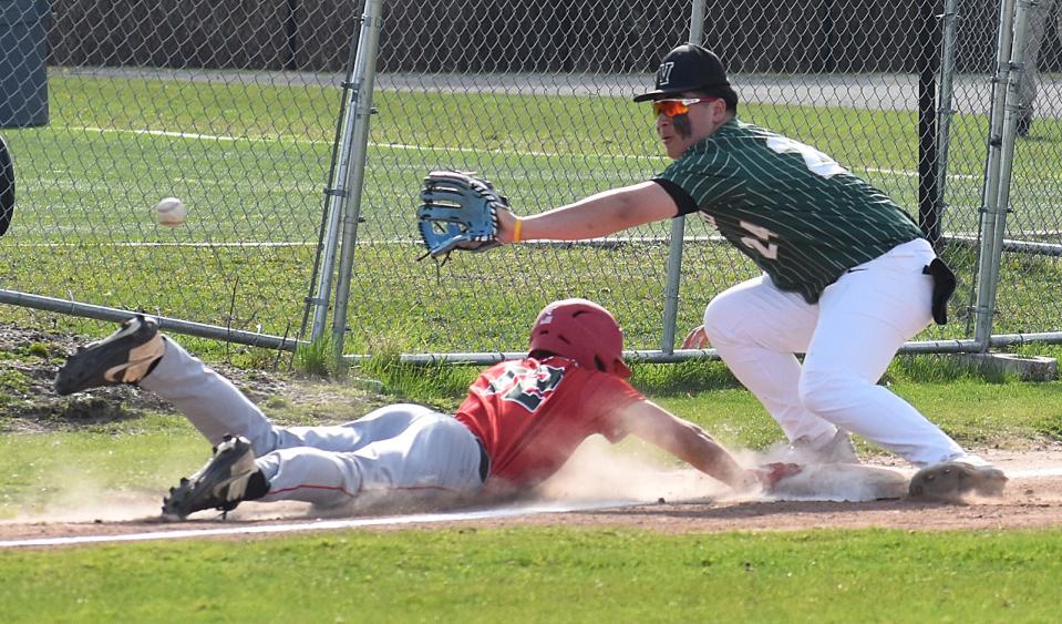 Durfee's Ben Sherry slides back to third before the tag of Greater New Bedford's Cam Cabral during last season's game.