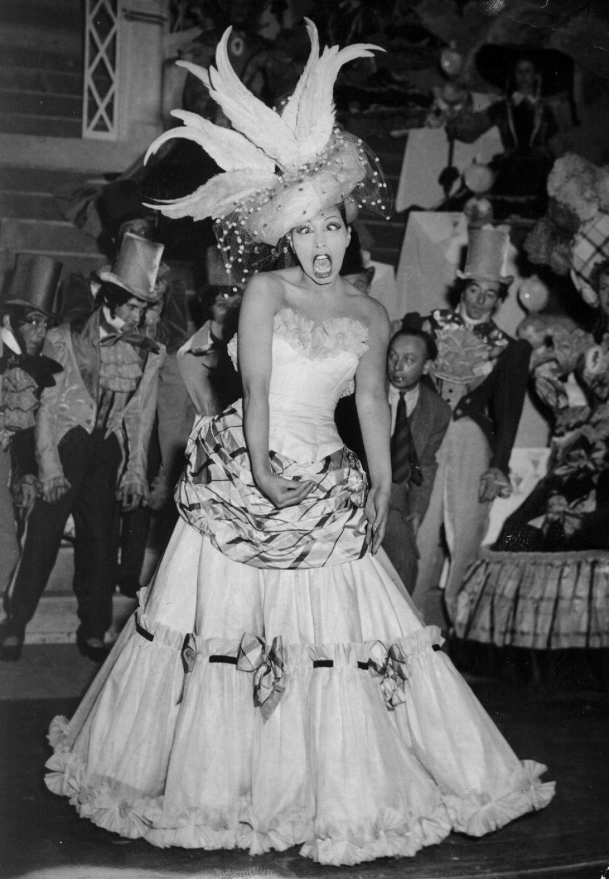 FILE - In this Feb. 21, 1949 file photo, singer and dancer Josephine Baker performs during a show in Paris. The remains of American-born singer and dancer Josephine Baker will be reinterred at the Pantheon monument in Paris, making the entertainer who is a World War II hero in France the first Black woman to get the countryâ€™s highest honor. Le Parisien newspaper reported Sunday Aug. 22, 2021, that French President Emmanuel Macron decided to organize a ceremony on November 30 at the Paris monument.  (AP Photo/File)