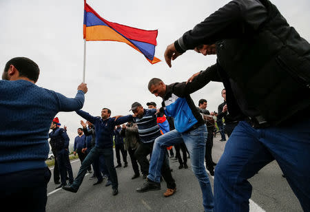 Local residents dance as they wait for arrival of supporters of Armenian opposition leader Nikol Pashinyan on their way to Ijevan, in the town of Abovyan, Armenia April 28, 2018. REUTERS/Gleb Garanich